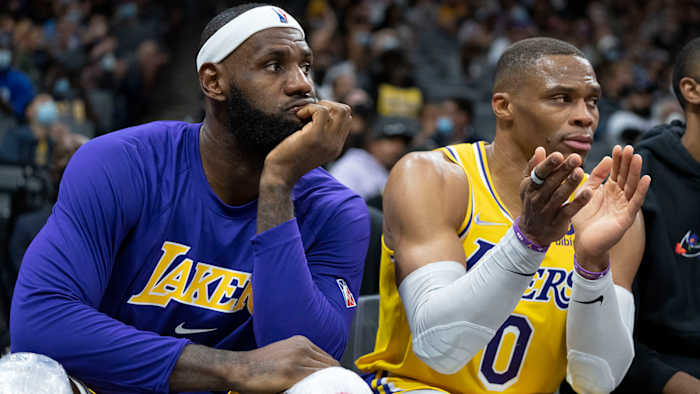 Los Angeles Lakers forward LeBron James (6, left) and guard Russell Westbrook (0) sit on the bench during the fourth quarter.